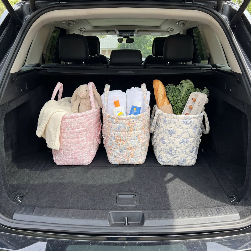 Quilty storage baskets organizing items in a car trunk